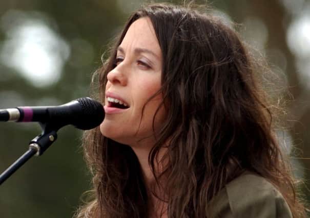Alanis Morissette performs in 2003 when life somehow seemed simpler (Picture: Tim Mosenfelder/Getty Images)