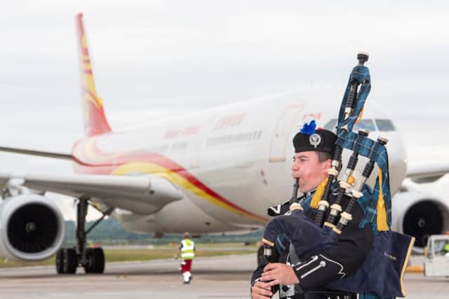 A piper welcomes the first Hainan Airlines flight as it lands at Edinburgh Airport after a flight direct from Chinas capital Beijing (Picture: Ian Georgeson)