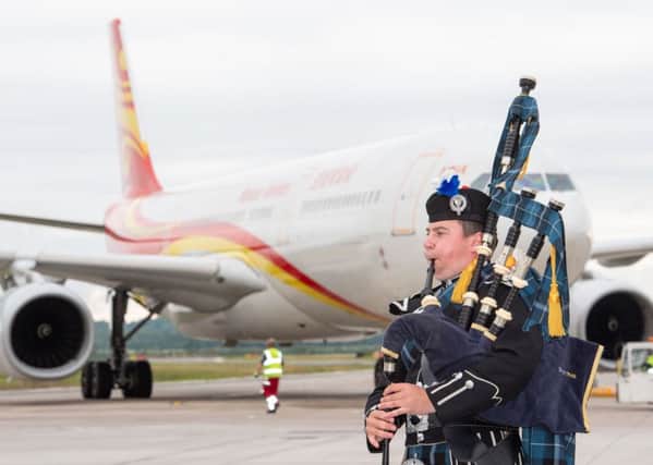 A piper welcomes the first Hainan Airlines flight as it lands at Edinburgh Airport after a flight direct from Chinas capital Beijing (Picture: Ian Georgeson)
