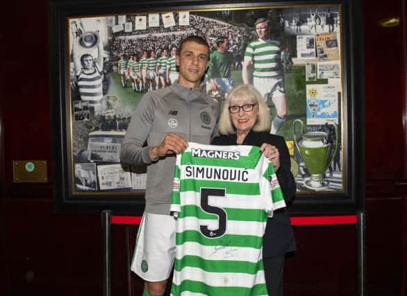 Jozo Simunovic presents his No.5 shirt to Billy McNeill's widow Liz. Picture: SNS Group