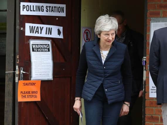 Theresa May goes to vote in the English council elections. Picture PA