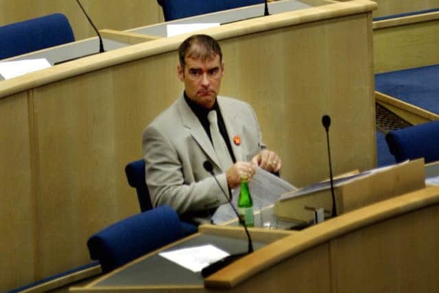 SSP MSP Tommy Sheridan takes his seat in the former Scottish Parliament debating chamber on The Mound in 2002. Picture: David Cheskin/PA