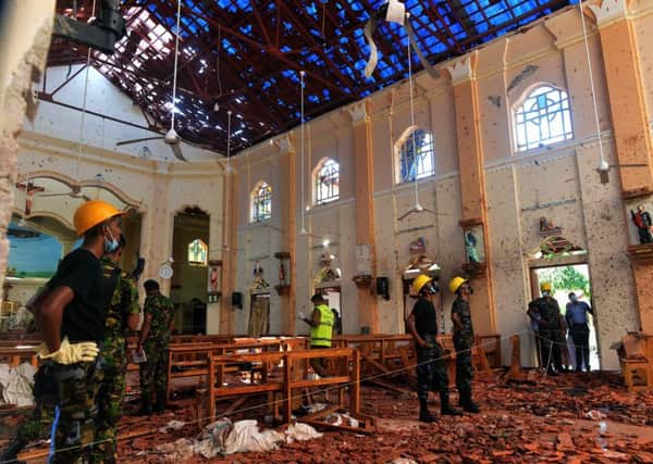 Security personnel inspect the interior of St. Sebastian's Church in Negombo a day after the church was hit in series of bomb blasts targeting churches and luxury hotels in Sri Lanka. Picture: AFP/Getty Images