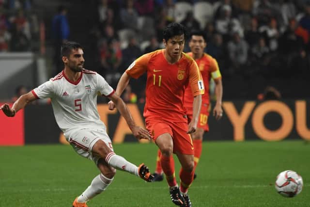 Milad Mohammadi plays the ball as Hao Junmin of China keeps tabs on the Iran defender during the 2019 Asian Cup. Picture: Getty Images