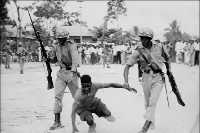 Soldiers of the new Democratic Republic of Congo arrest a demonstrator on 05 July 1960
