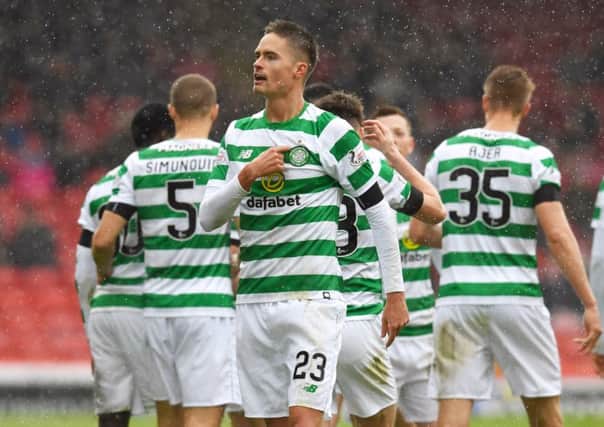 Celtic's Mikael Lustig celebrates his opener. Pic: SNS/Craig Williamson