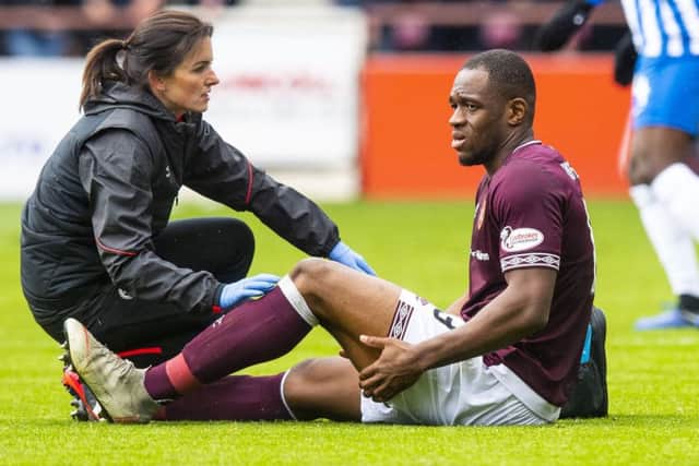 Hearts' Uche Ikpeazu goes off with an apparent hamstring injury in the second half. Pic: SNS/Ross Parker
