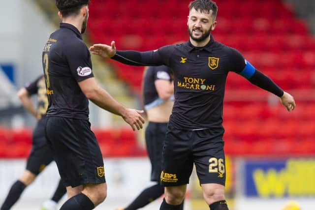 Livingston's Craig Halkett celebrates his goal with teammate Rickie Lamie. Pic: SNS/Ross MacDonald