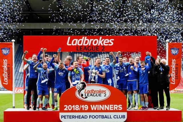 The Peterhead players celebrate clinching promotion. Pic: SNS/Gary Hutchison