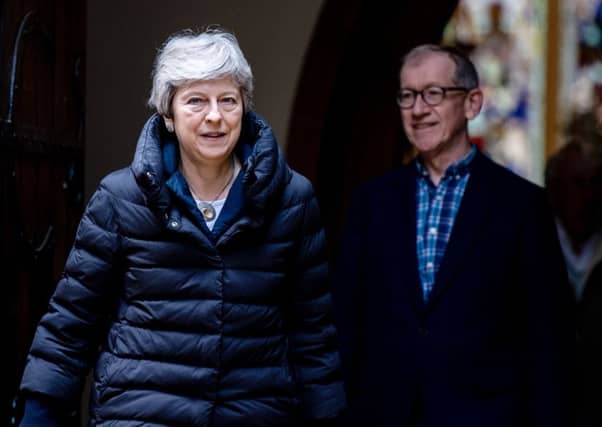 Theresa May and her husband Philip leave after attending a Sunday service at her local church on May 5. Picture: Getty