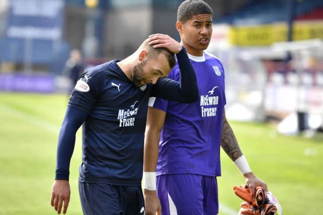 Dundee duo James Horsfield, left, and Seny Dieng trudge off the field at Dens Park after defeat by Hamilton confirmed their relegation. Picture: SNS.