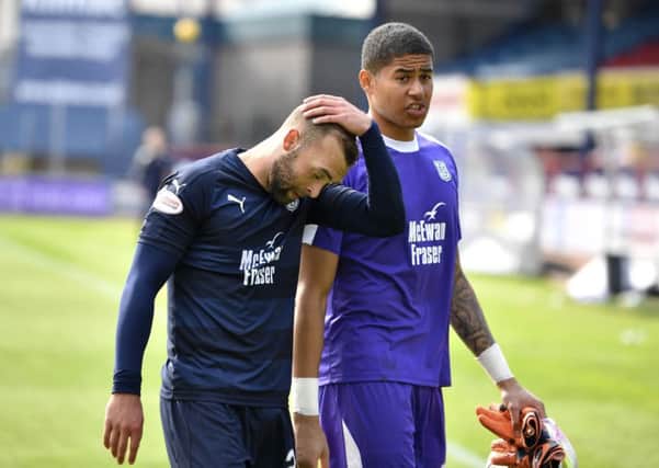 Dundee duo James Horsfield, left, and Seny Dieng trudge off the field at Dens Park after defeat by Hamilton confirmed their relegation. Picture: SNS.