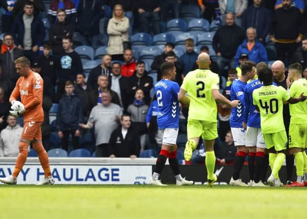 Allan McGregor gets his marching orders at  Ibrox yesterday after kicking out at Hibs  Marc McNulty.