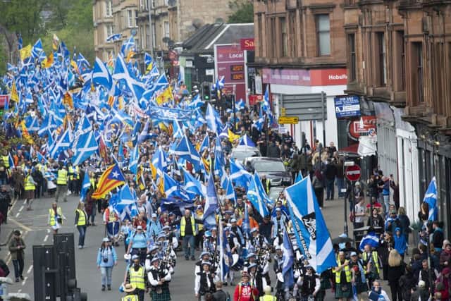 Scottish independence supporters march through Glasgow during the All Under One Banner march on Saturday