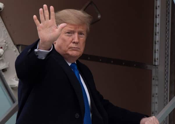 US President Donald Trump waves as he boards Air Force One at Andrews Air Force Base, MD, (Photo by Jim WATSON / AFP)JIM WATSON/AFP/Getty Images