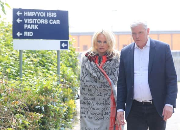 US actress Pamela Anderson leaves Belmarsh Prison in south-east London, accompanied by WikiLeaks editor Kristinn Hrafnsson after she visited WikiLeaks founder Julian Assange. Picture: Gareth Fuller/PA Wire