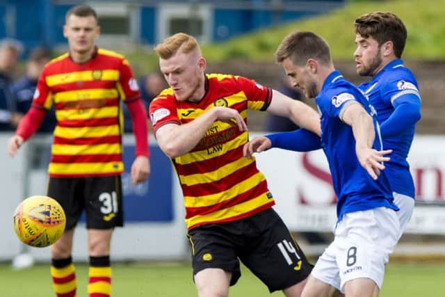 Andrew Stirling and Kyle Jacobs of Queen of the South battle with Partick's Shea Gordon during a Championship clash. Picture: SNS Group