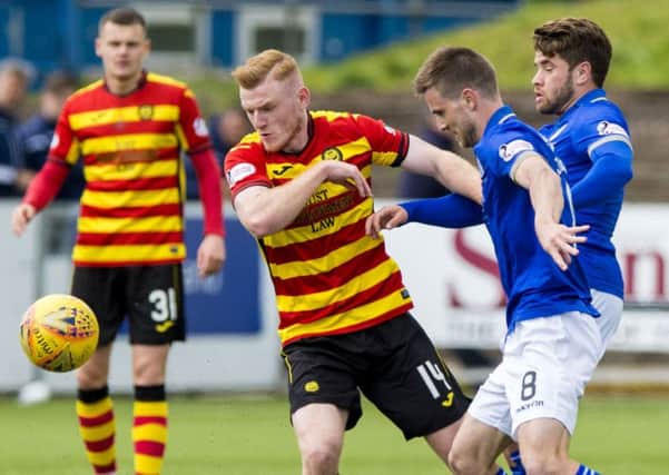 Andrew Stirling and Kyle Jacobs of Queen of the South battle with Partick's Shea Gordon during a Championship clash. Picture: SNS Group