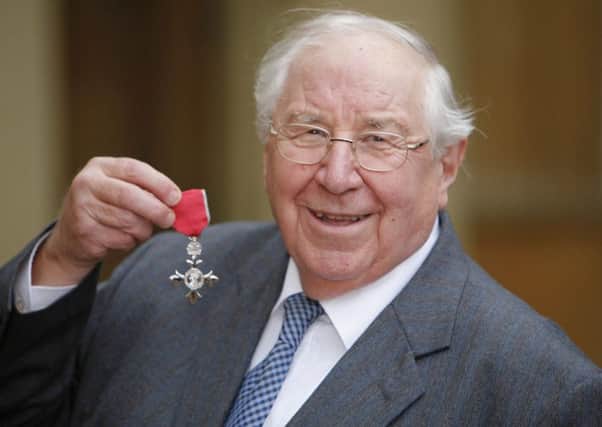 Antiques Roadshow expert Henry Sandon pictured receiving his OBE. Picture: SWNS