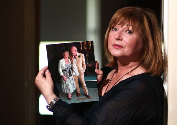 Portrait of Joan McLellan, who lost her husband, Ross, earlier this year. Joan is holding a wedding photograph of her and Ross.

 Pic: John Devlin