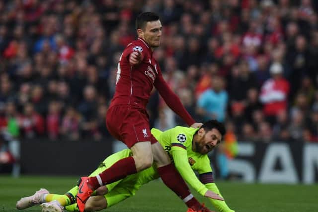 Liverpool defender Andy Robertson tangles with Barcelona's Lionel Messi during the epic Anfield clash. Picture: Paul Ellis/AFP/Getty
