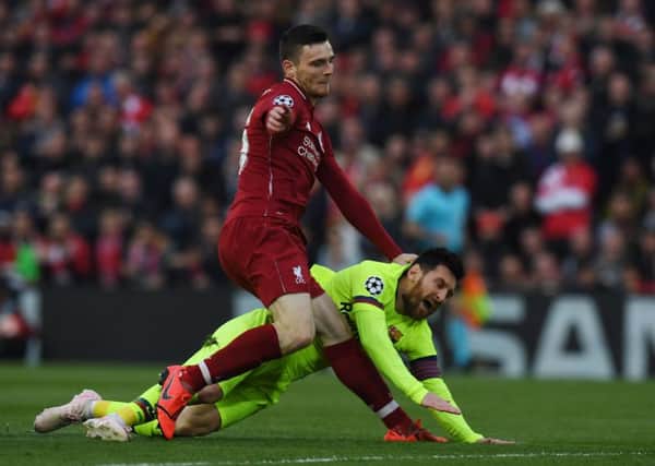 Liverpool defender Andy Robertson tangles with Barcelona's Lionel Messi during the epic Anfield clash. Picture: Paul Ellis/AFP/Getty