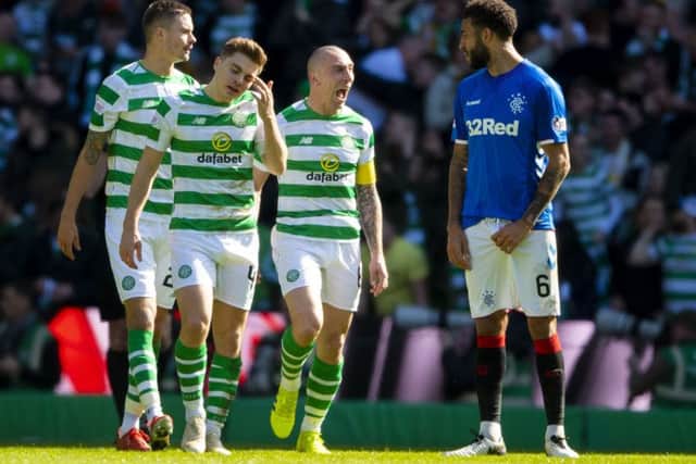 Scott Brown exchanges words with Connor Goldson after Celtic opened the scoring in the last Old Firm derby in March. Picture: SNS