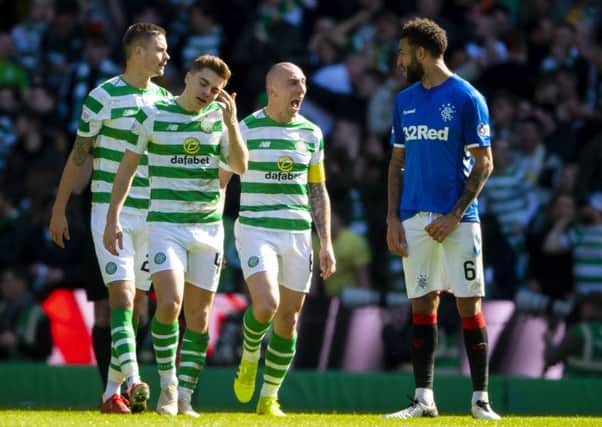 Scott Brown exchanges words with Connor Goldson after Celtic opened the scoring in the last Old Firm derby in March. Picture: SNS