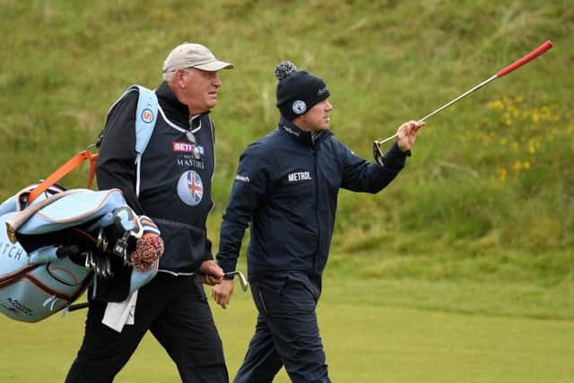Richie Ramsay walks down the 8th with caddie Guy Tilston. Picture: Ross Kinnaird/Getty