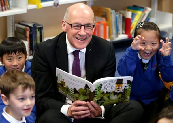 Education Secretary John Swinney reads to pupils in Edinburgh. Picture: Jane Barlow/PA