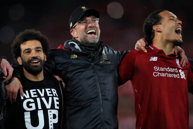Liverpool's Mohamed Salah, manager Jurgen Klopp (centre) and Virgil van Dijk celebrate after beating Barcelona. Pic: Peter Byrne/PA Wire.