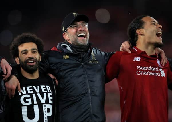 Liverpool's Mohamed Salah, manager Jurgen Klopp (centre) and Virgil van Dijk celebrate after beating Barcelona. Pic: Peter Byrne/PA Wire.