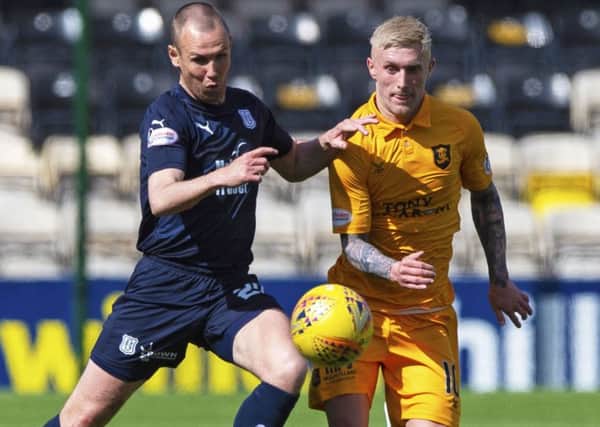 Dundee's Kenny Miller competes with Livingston's Craig Sibbald. Pic: SNS/Ross MacDonald