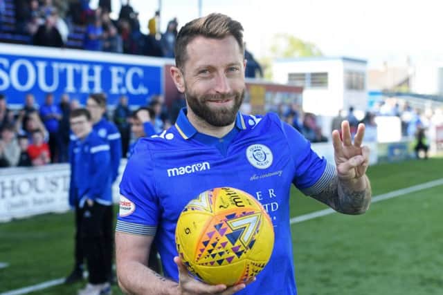 Queen of the South's Stephen Dobbie poses with the match ball after scoring a hat trick. Pic: SNS/Craig Foy