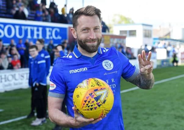 Queen of the South's Stephen Dobbie poses with the match ball after scoring a hat trick. Pic: SNS/Craig Foy