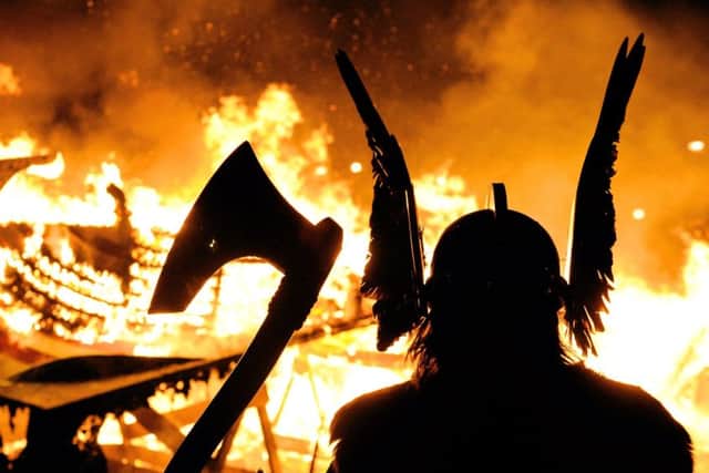 The Guizer Jarl or Chief of the Jarl viking squad is silhoutted by a burning viking longship during the annual Up Helly Aa Festival, Lerwick, Shetland Islands. Picture: CARL DE SOUZA/AFP/Getty Images