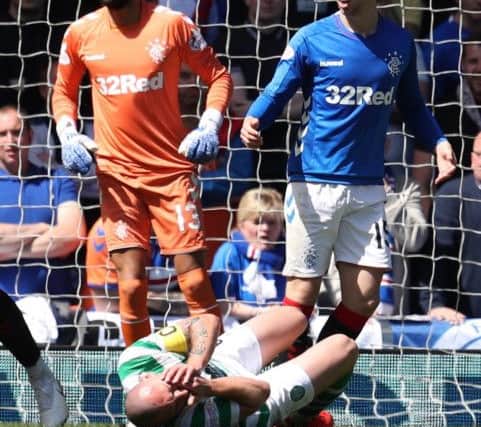 Brown holds his face after clashing with Rangers defender Jon Flanagan. Picture: PA