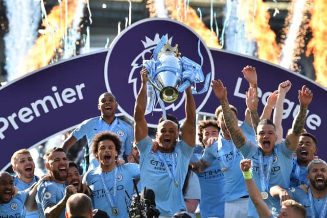 Manchester City captain Vincent Kompany holds the Premier League trophy aloft. Picture: AFP/Getty.