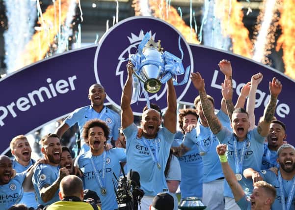 Manchester City captain Vincent Kompany holds the Premier League trophy aloft. Picture: AFP/Getty.