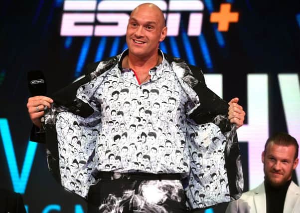 Tyson Fury shows off his shirt featuring drawings of former world heavyweight champions. Picture: Kirsty O'Connor/PA Wire