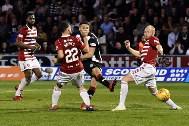Kyle Magennis slots home St Mirrens second goal in added time to seal their 2-0 victory over Hamilton in Paisley last night. Picture: SNS