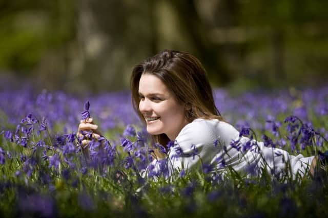 A young woman laying in a field of bluebells. Pic: File
