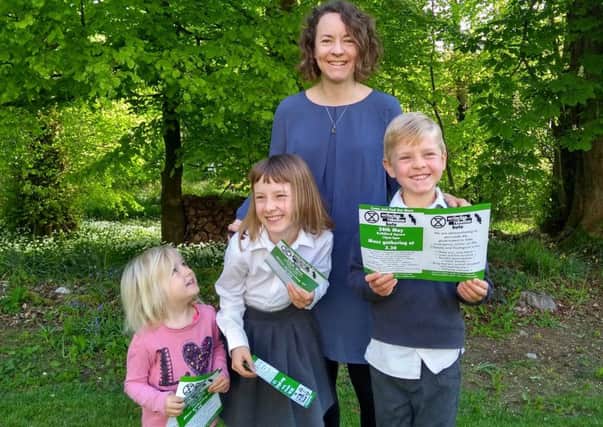 Emma Thomas and her children with leaflets for Extinction Rebellion Bute event.