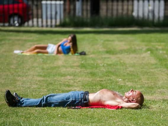 Sunbathing topless in Scotland's park is fairly common - but is it legal?