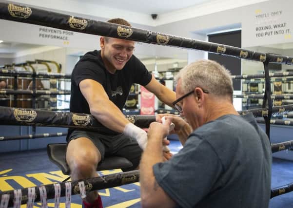 World-renowned trainer Freddie Roach tapes up the right hand of Ivan Baranchyk as the Belarusian prepares to face Josh Taylor. Picture: SNS