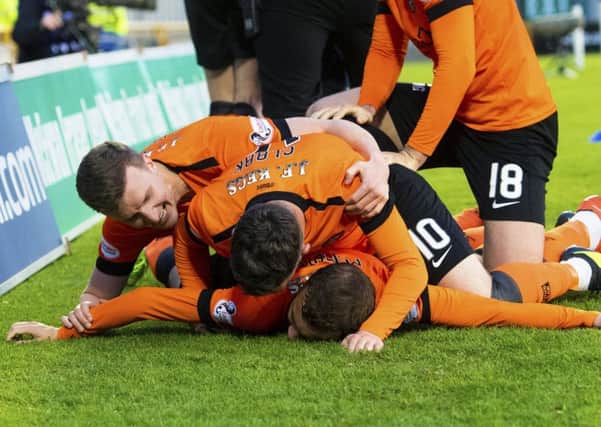 Paul McMullan is mobbed by his Dundee United team-mates after scoring the only goal against Inverness Caley Thistle. Picture: Bill Murray/SNS