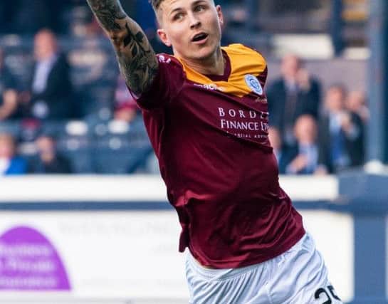 Lyndon Dykes wheels away in delight after making it 1-0 to Queen of the South