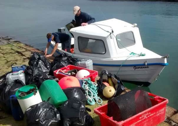 A boat owned by Kevin Byrne unloads bags of plastic rubbish like old fishing twine. Picture: SWNS