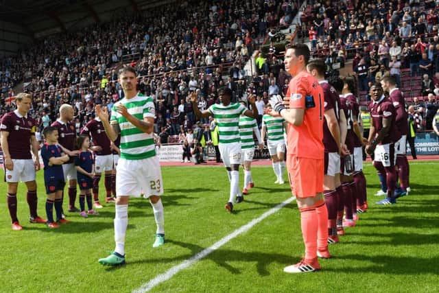 The Hearts players give the champions Celtic a guard of honour as they walk out onto the pitch at Tynecastle last season. Picture: SNS