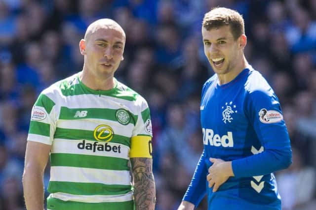 Jon Flanagan (right) shares a joke with Celtic's Scott Brown during the Old Firm clash. Picture: SNS Group